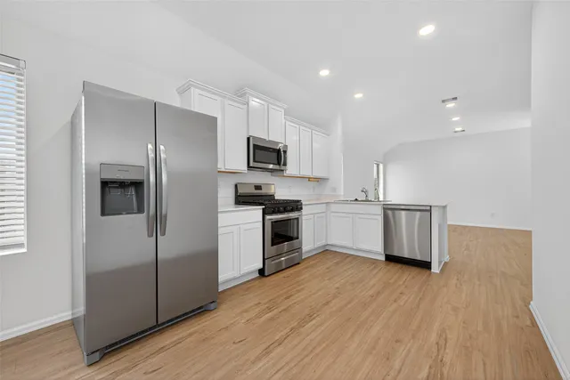 a kitchen with a refrigerator a microwave oven and a sink