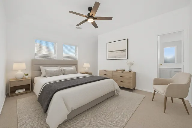 a bedroom with a bed a couch and a window