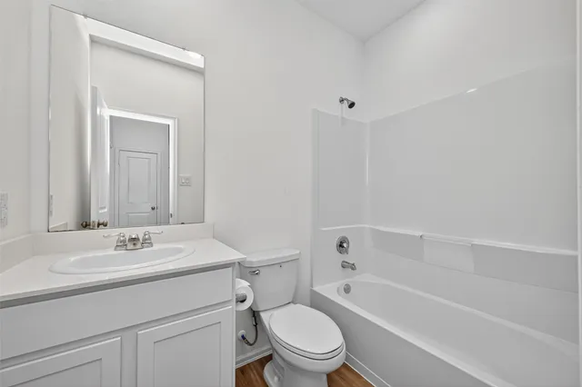 a bathroom with a sink toilet vanity and shower
