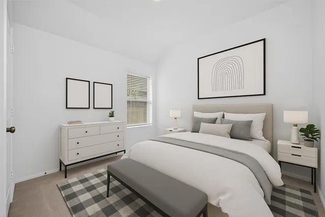 a bedroom with a bed and a dresser