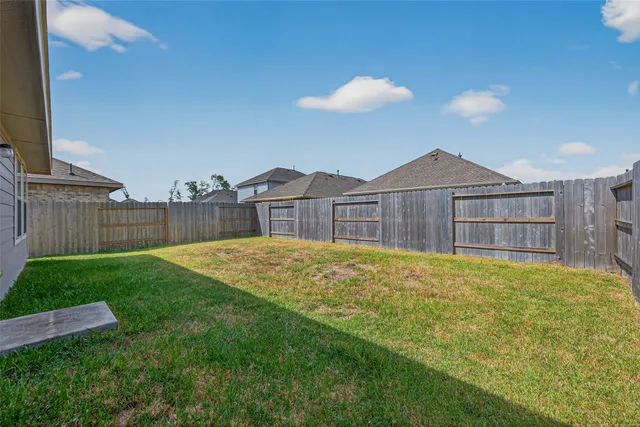 a view of a house with a backyard and a table and chairs