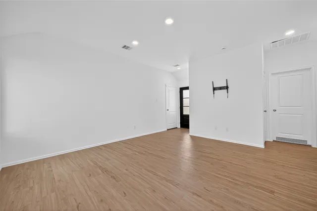 an empty room with wooden floor