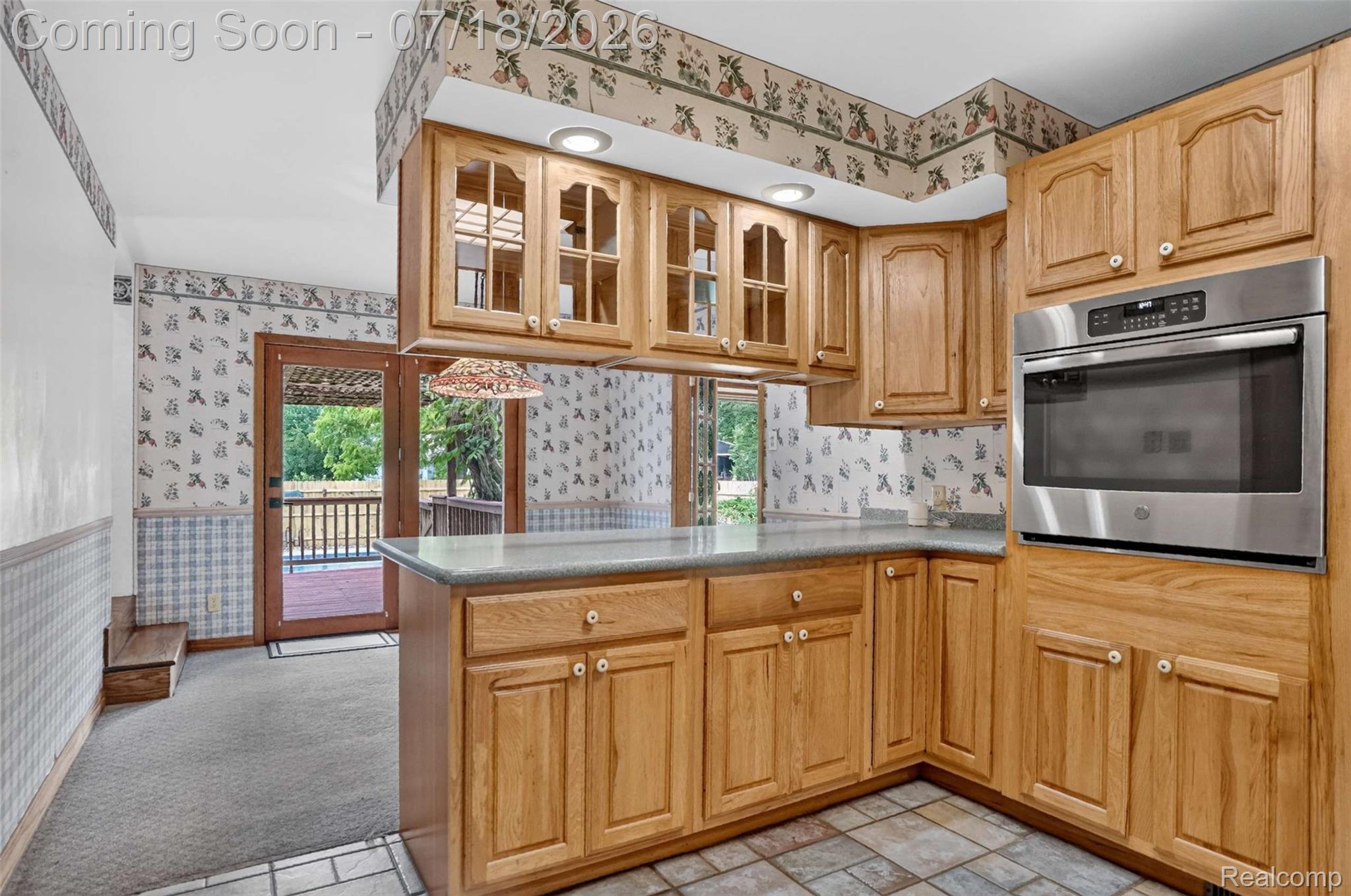 1437 East Cook Road Grand Blanc, MI 48439 - Photo 47 of 69 Kitchen featuring wood cabinetry, an integrated stainless steel wall oven, light-toned countertops, and a tile floor