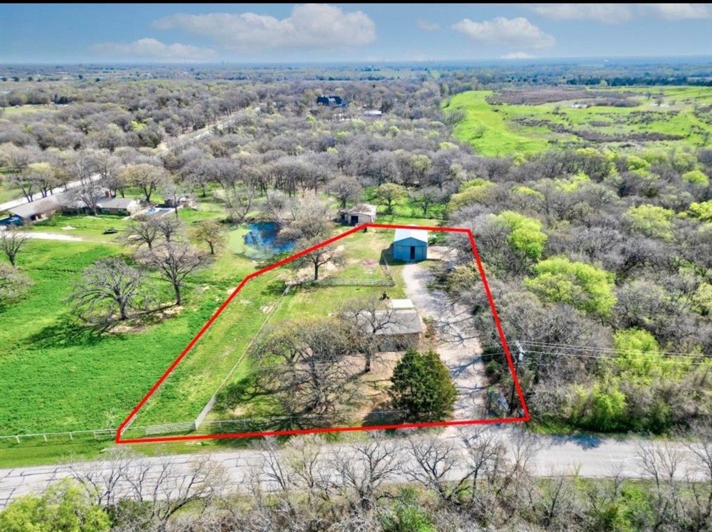 3900 Moseley Road Cross Roads, TX 76227 - Photo 33 of 36 Expansive property featuring a private pond, mature trees, and a detached blue outbuilding