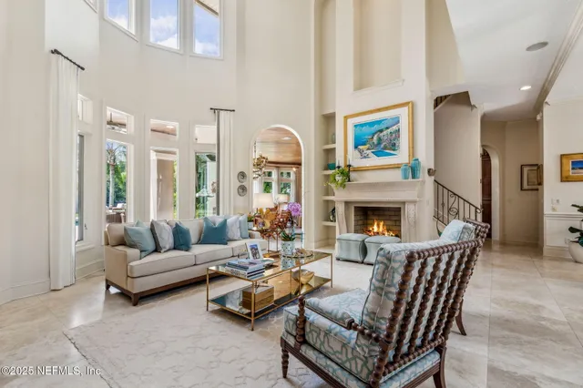 a living room with fireplace furniture and a flat screen tv