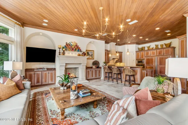 a kitchen with a sink and a large mirror with potted plant