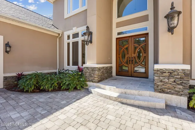 a living room with furniture a rug and a large window