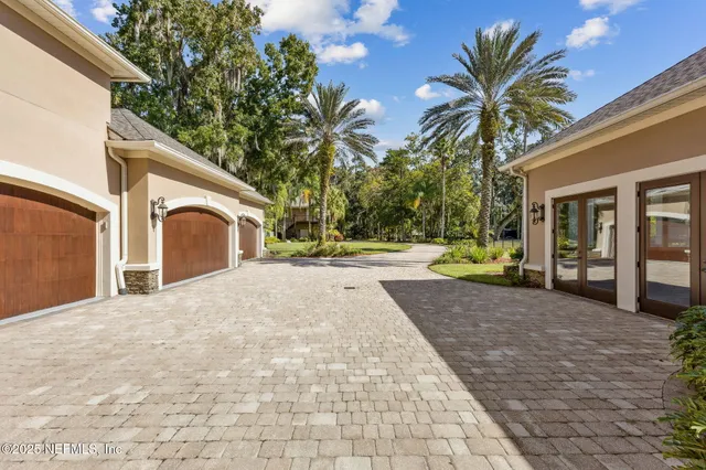 a view of a dining room with furniture a chandelier and wooden floor