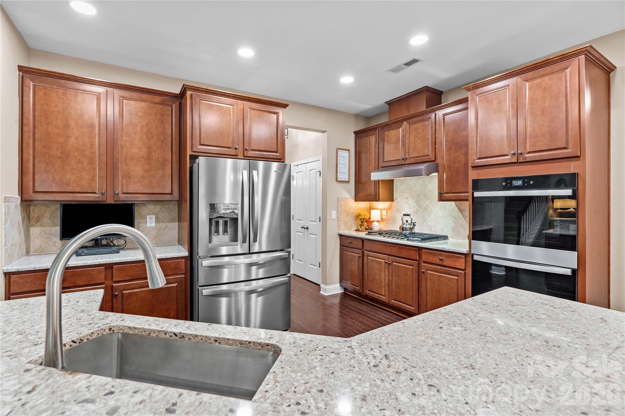 106 Dayvault Cut Road Troutman, NC 28166 - Photo 12 of 48 a kitchen with stainless steel appliances granite countertop a refrigerator a stove top oven and sink