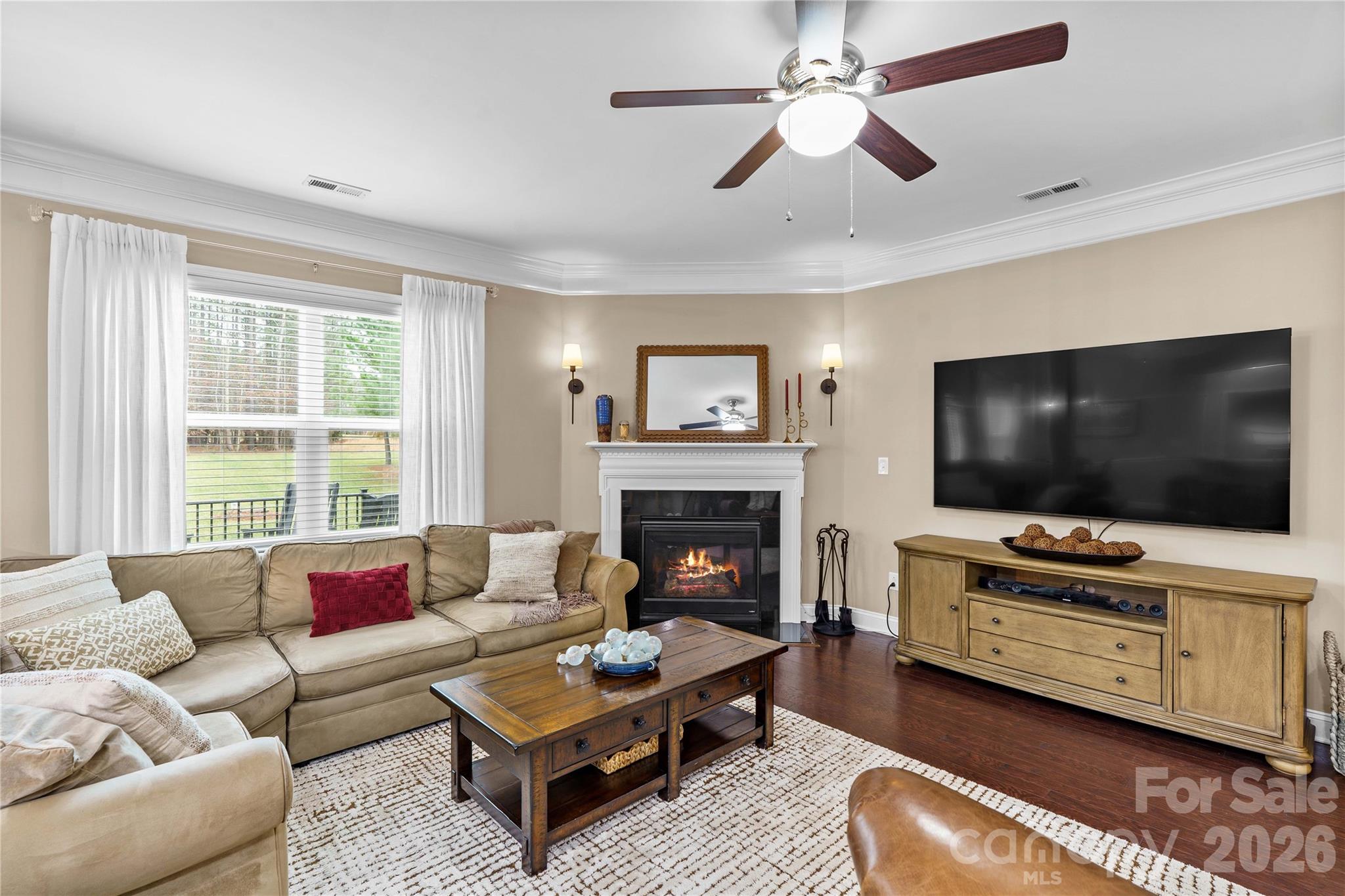 106 Dayvault Cut Road Troutman, NC 28166 - Photo 21 of 48 a living room with furniture a flat screen tv and a fireplace