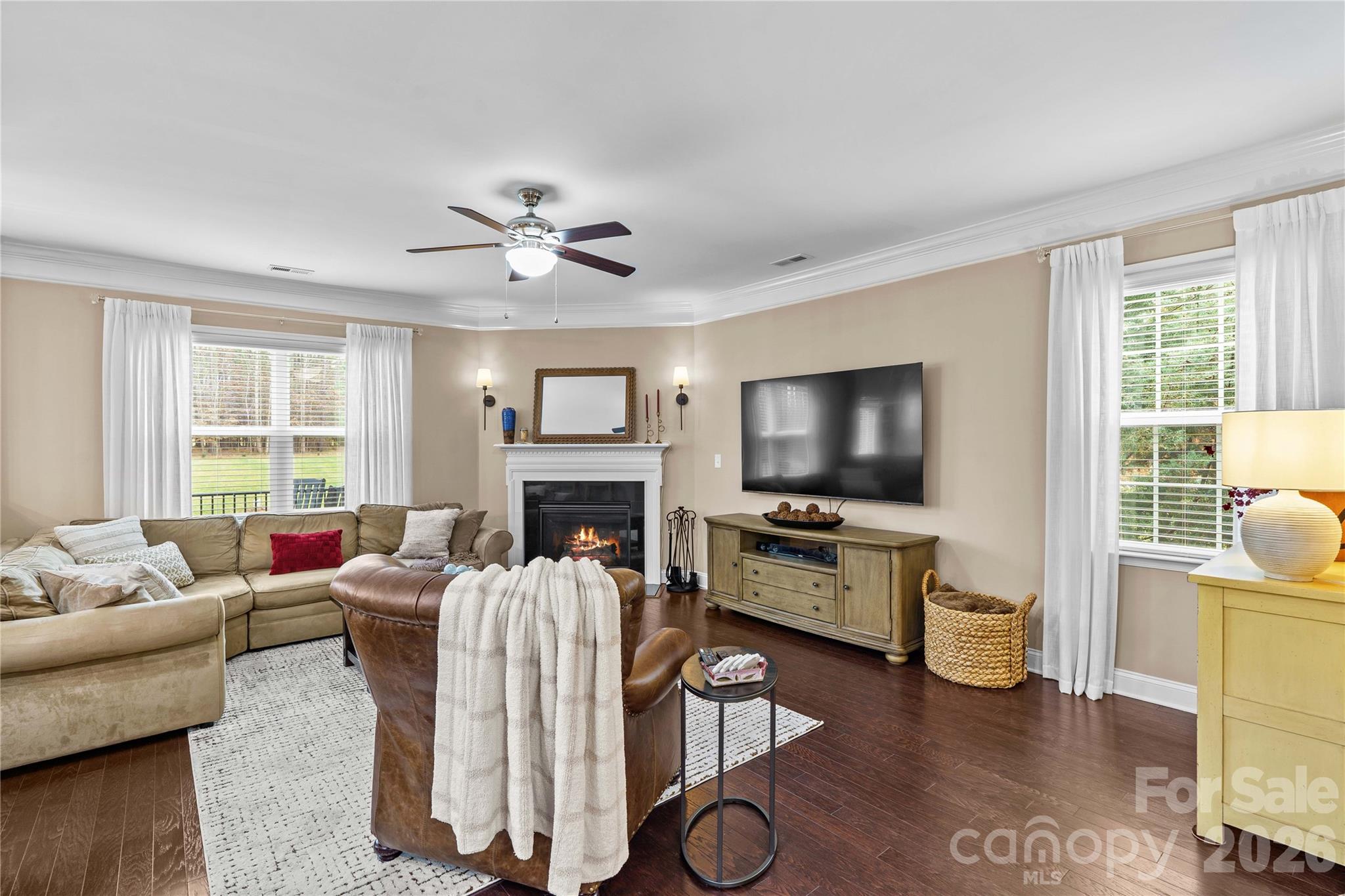 106 Dayvault Cut Road Troutman, NC 28166 - Photo 22 of 48 a living room with furniture a flat screen tv and a fireplace
