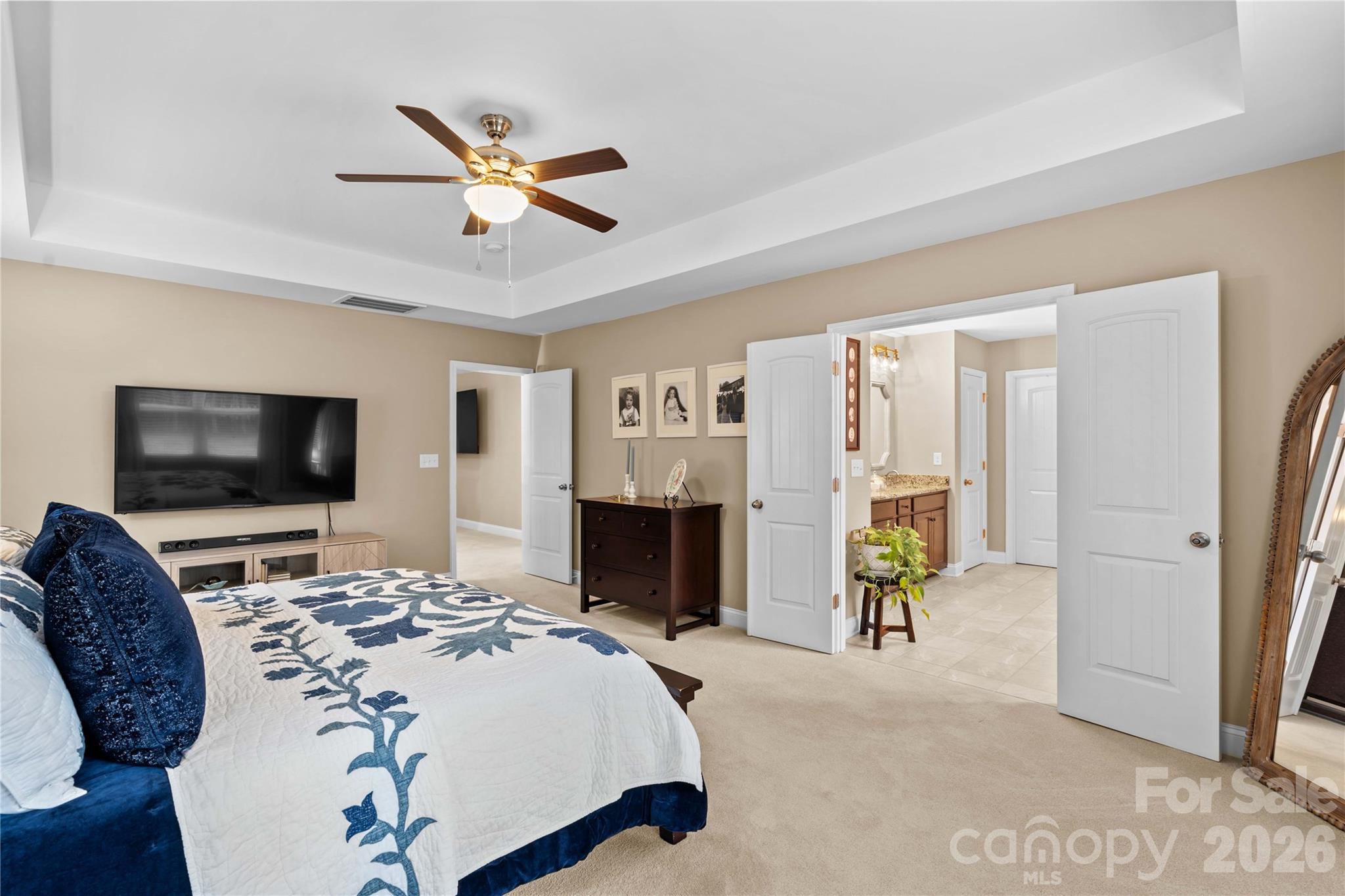 106 Dayvault Cut Road Troutman, NC 28166 - Photo 29 of 48 a bedroom with a bed and a flat screen tv