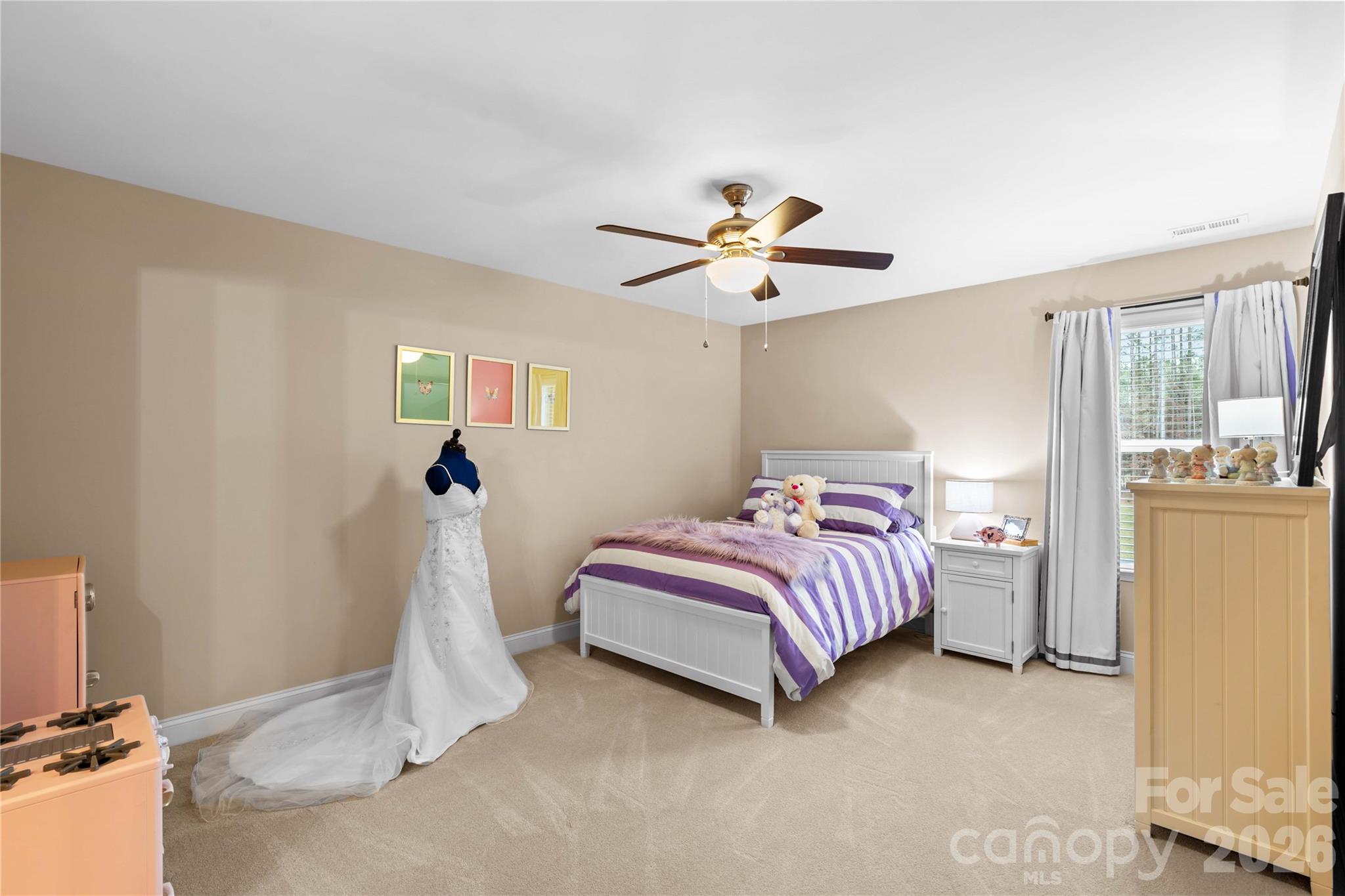 106 Dayvault Cut Road Troutman, NC 28166 - Photo 34 of 48 a bedroom with a bed and a chandelier