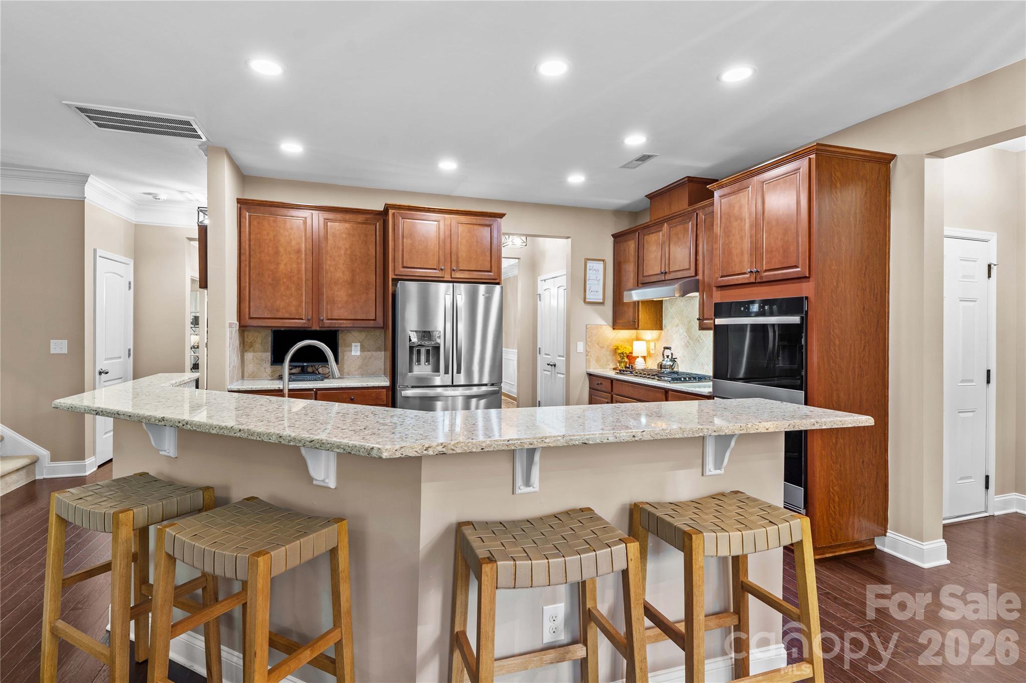 106 Dayvault Cut Road Troutman, NC 28166 - Photo 10 of 48 a kitchen with stainless steel appliances granite countertop white cabinets a sink and a stove
