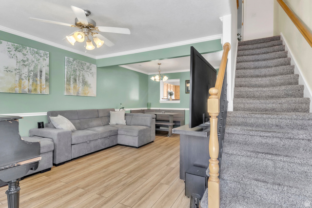 814 North 175 East Springville, UT 84663 - Photo 3 of 18 Living area with light wood-type flooring, a chandelier, stairs, crown molding, and a ceiling fan