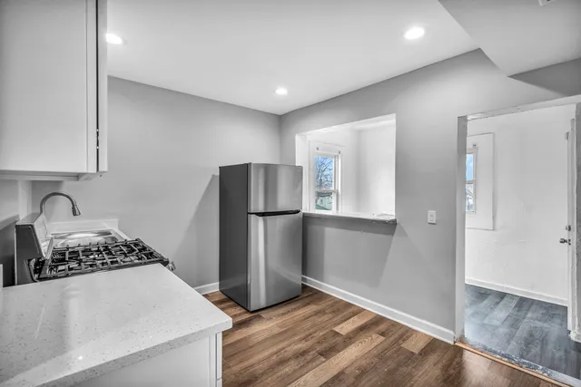 a kitchen with stainless steel appliances granite countertop a refrigerator and a stove