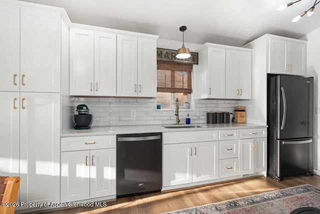a kitchen with stainless steel appliances granite countertop a refrigerator sink and cabinets