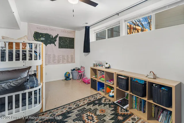 a room with furniture a rug and a window