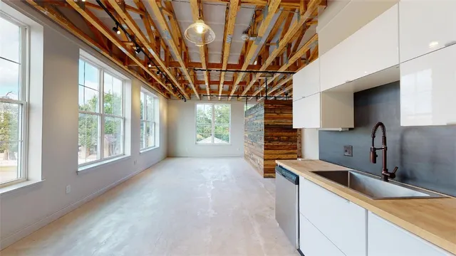 a kitchen with stainless steel appliances granite countertop a sink window and refrigerator