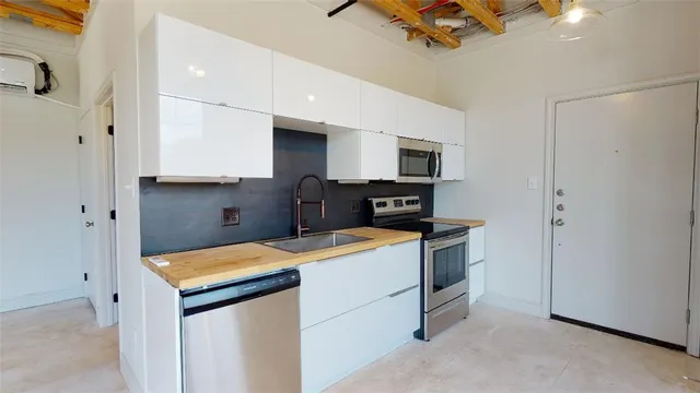 a kitchen that has a sink and a stove in it