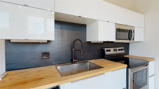 a kitchen with a sink and a stove top oven