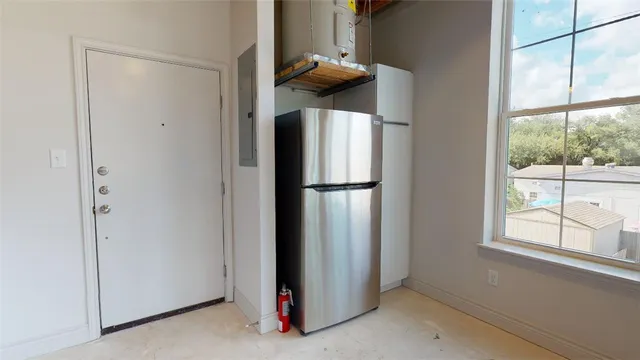 a kitchen with a refrigerator and window