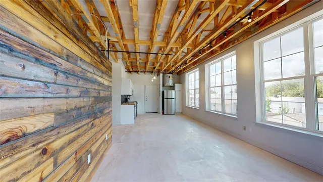 a view of an empty room with windows