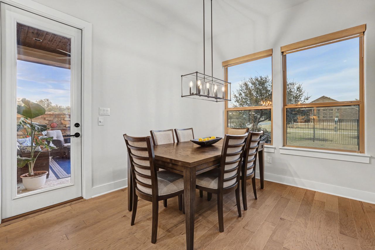 2408 Nate's Place Georgetown, TX 78633 - Photo 15 of 40 Dining room featuring light wood finished floors and a chandelier
