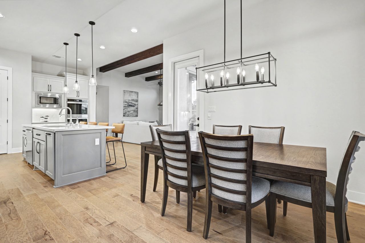 2408 Nate's Place Georgetown, TX 78633 - Photo 16 of 40 Dining room featuring light wood-style floors, beamed ceiling, and hanging lights