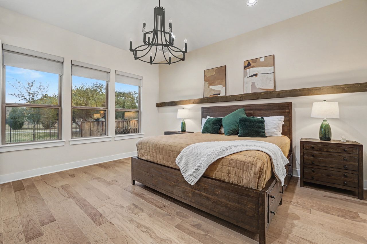 2408 Nate's Place Georgetown, TX 78633 - Photo 18 of 40 Bedroom with light wood-style floors and a chandelier