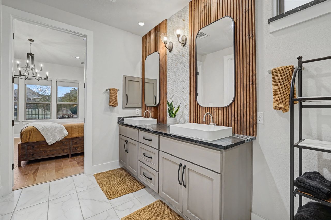 2408 Nate's Place Georgetown, TX 78633 - Photo 21 of 40 Full bath with ensuite bath, double vanity, light marble finish flooring, and hanging lights
