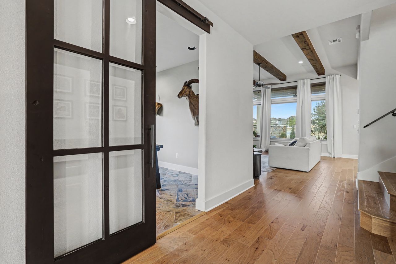 2408 Nate's Place Georgetown, TX 78633 - Photo 23 of 40 Corridor with beam ceiling, wood-type flooring, a barn door, and recessed lighting