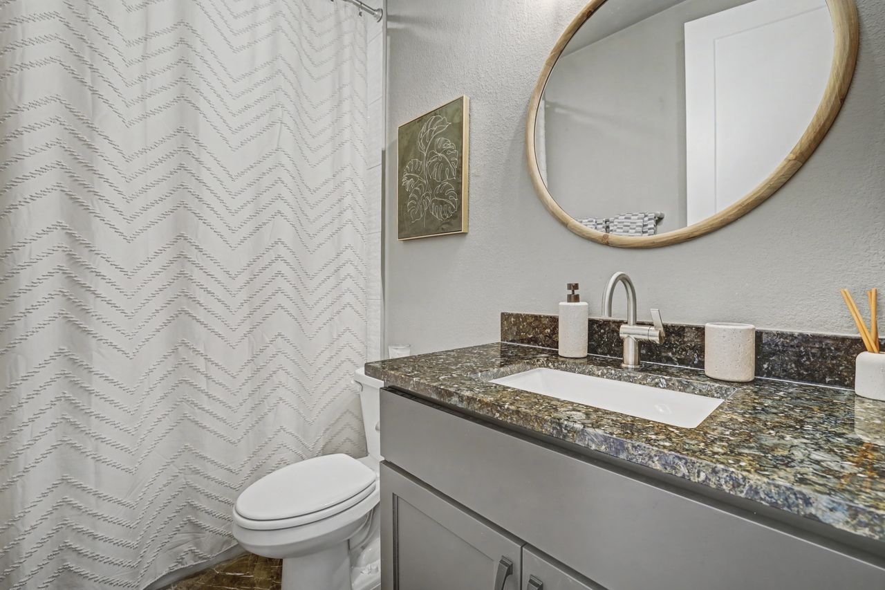 2408 Nate's Place Georgetown, TX 78633 - Photo 26 of 40 Full bathroom featuring a textured wall, a shower with curtain, and vanity