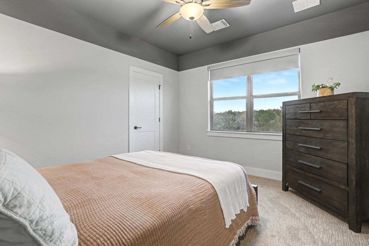 2408 Nate's Place Georgetown, TX 78633 - Photo 31 of 40 Carpeted bedroom featuring a ceiling fan and baseboards