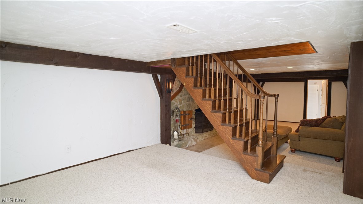 6676 Rochelle Boulevard Parma Heights, OH 44130 - Photo 15 of 21 Basement with light carpet and a fireplace