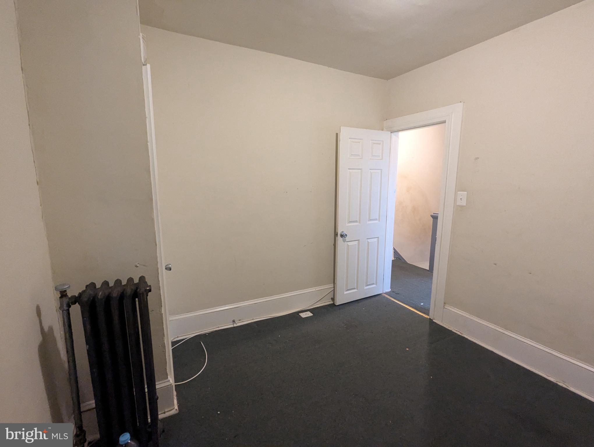 4133 Eierman Avenue Baltimore, MD 21206 - Photo 14 of 23 an empty room with wooden floor and mirror