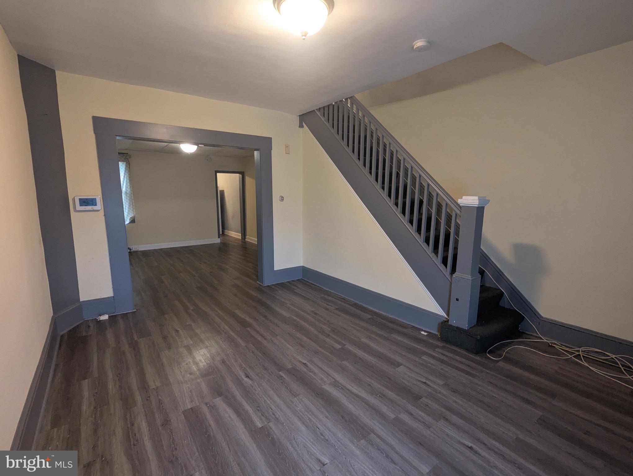 4133 Eierman Avenue Baltimore, MD 21206 - Photo 4 of 23 a view of a hallway with wooden floor and stairs