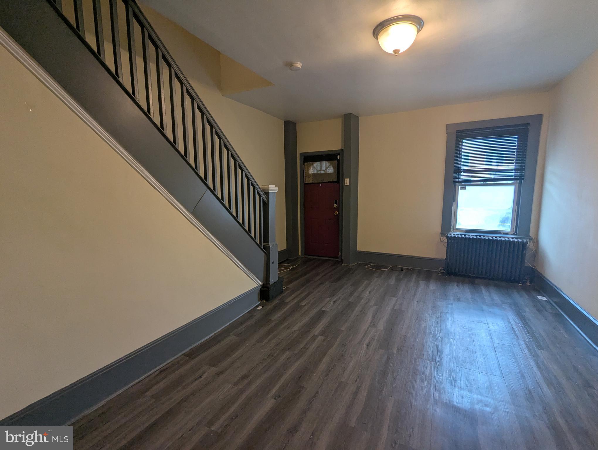 4133 Eierman Avenue Baltimore, MD 21206 - Photo 5 of 23 wooden floor in an empty room with a window