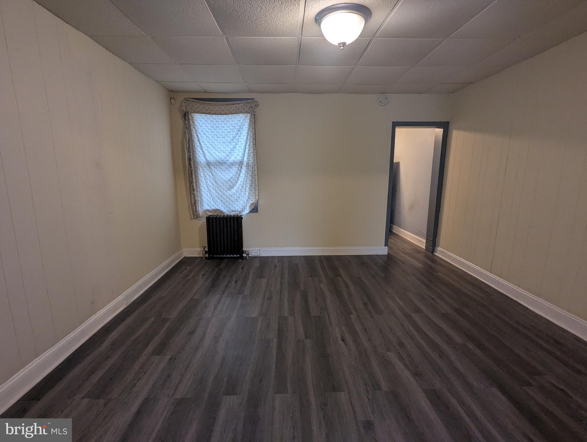4133 Eierman Avenue Baltimore, MD 21206 - Photo 6 of 23 a view of a room with wooden floor and window