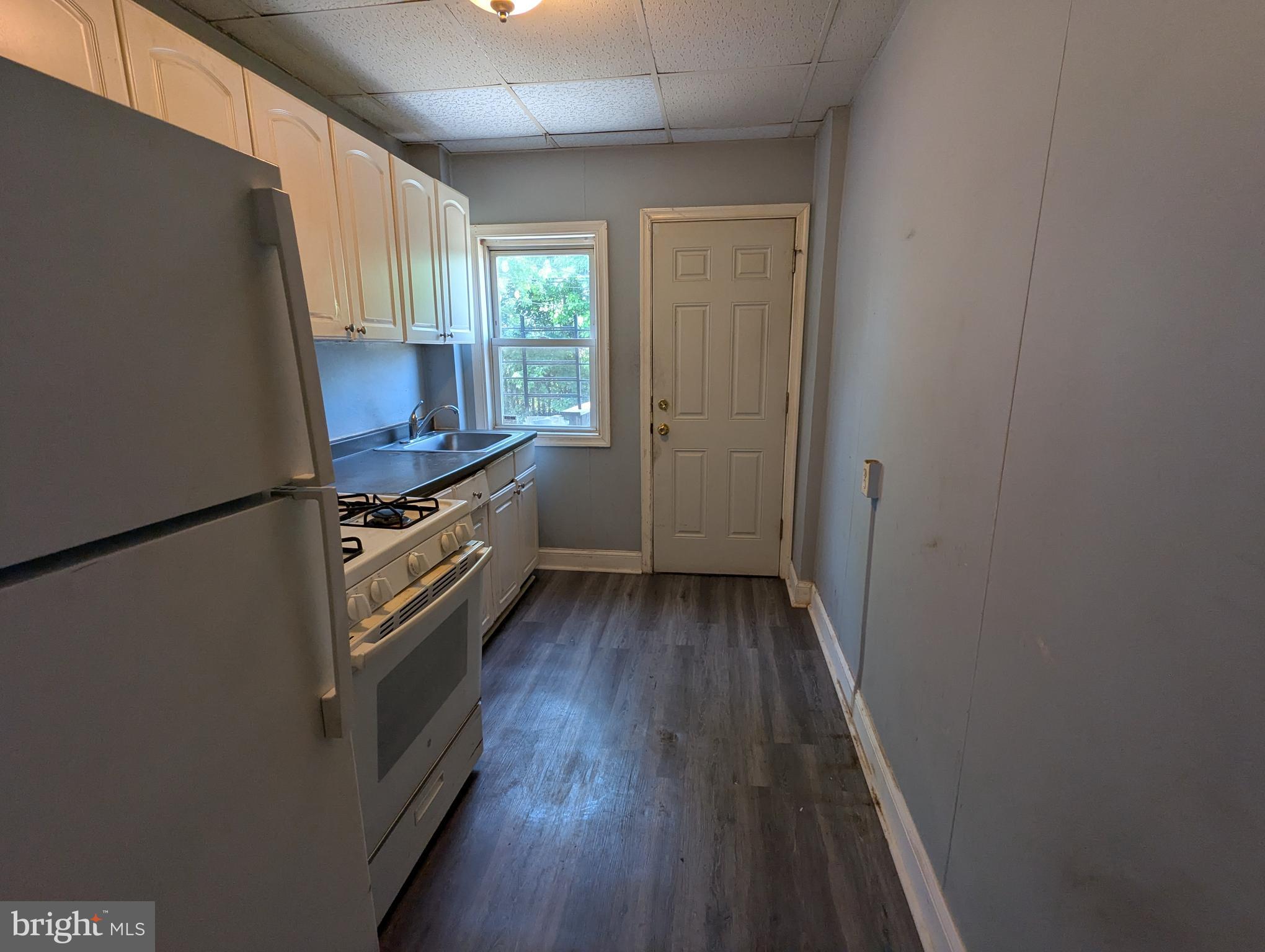 4133 Eierman Avenue Baltimore, MD 21206 - Photo 8 of 23 a kitchen with wooden floors and a sink