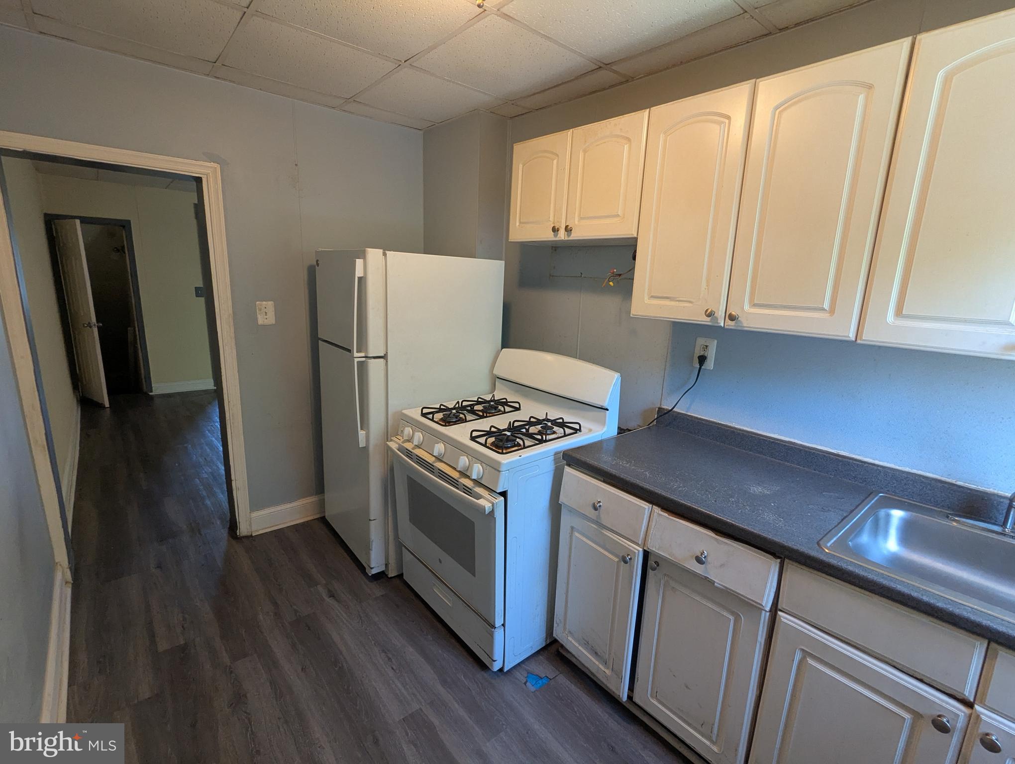 4133 Eierman Avenue Baltimore, MD 21206 - Photo 9 of 23 a kitchen with a stove and a refrigerator