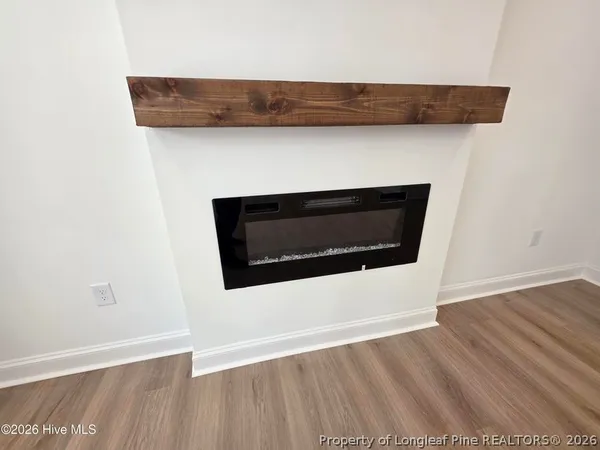 a utility room with wooden floor and fireplace