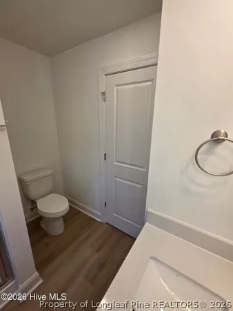 a bathroom with a granite countertop toilet and a shower