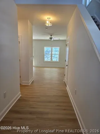 a view of a hallway with wooden floor
