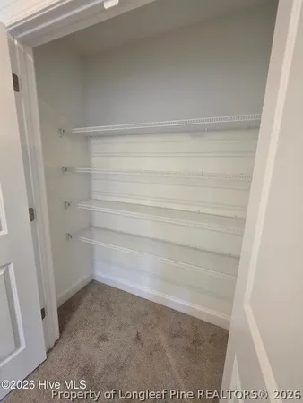 an empty room with windows and ceiling fan view