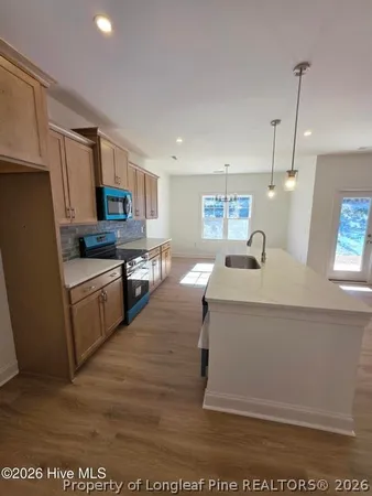 a kitchen with a sink appliances and cabinets