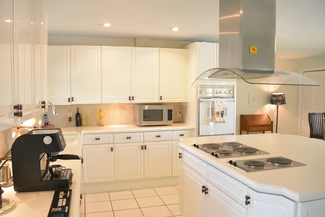 a kitchen with a stove a sink and a refrigerator