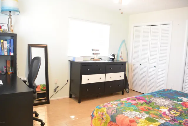 a bedroom with a bed and a dresser