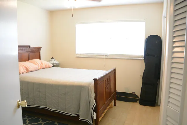 a bedroom with a bed and a window