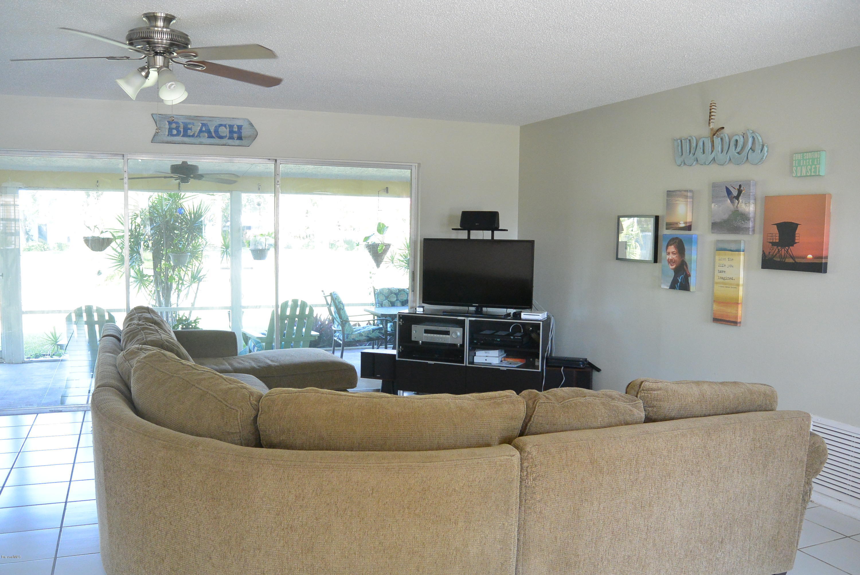 9 West Point Drive Cocoa Beach, FL 32931 - Photo 17 of 28 a living room with furniture and a flat screen tv